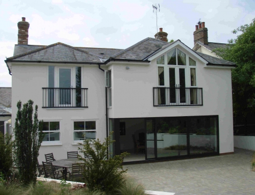 Two storey house extension with glass wall